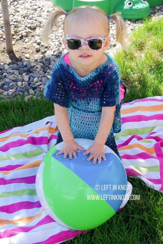 A crochet swim suit cover up for children