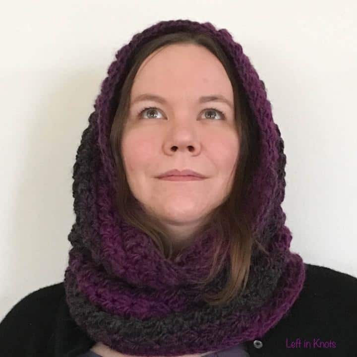 A woman wearing a crochet cowl hood