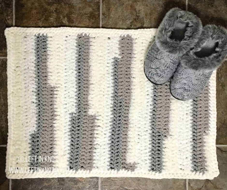 A crochet rug made with differently textured yarn