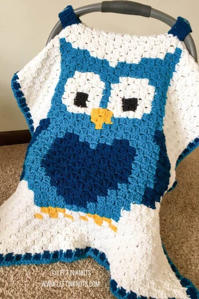 A C2C crochet car seat cover with an owl design