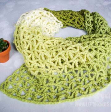 A green crochet triangle mesh wrap scarf