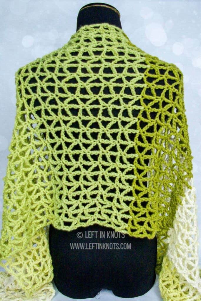 A green crochet triangle mesh wrap scarf