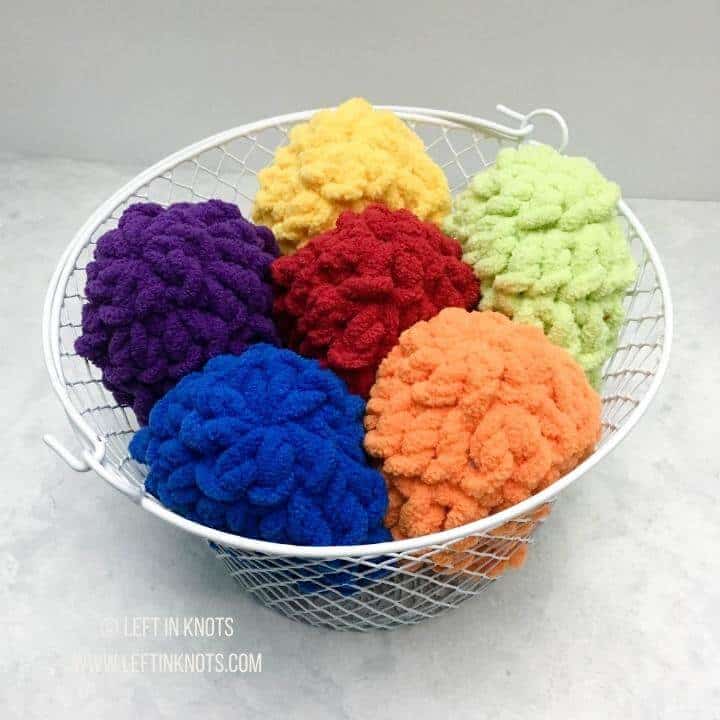 Colorful crochet reusable water balloons packaged for selling at craft fairs