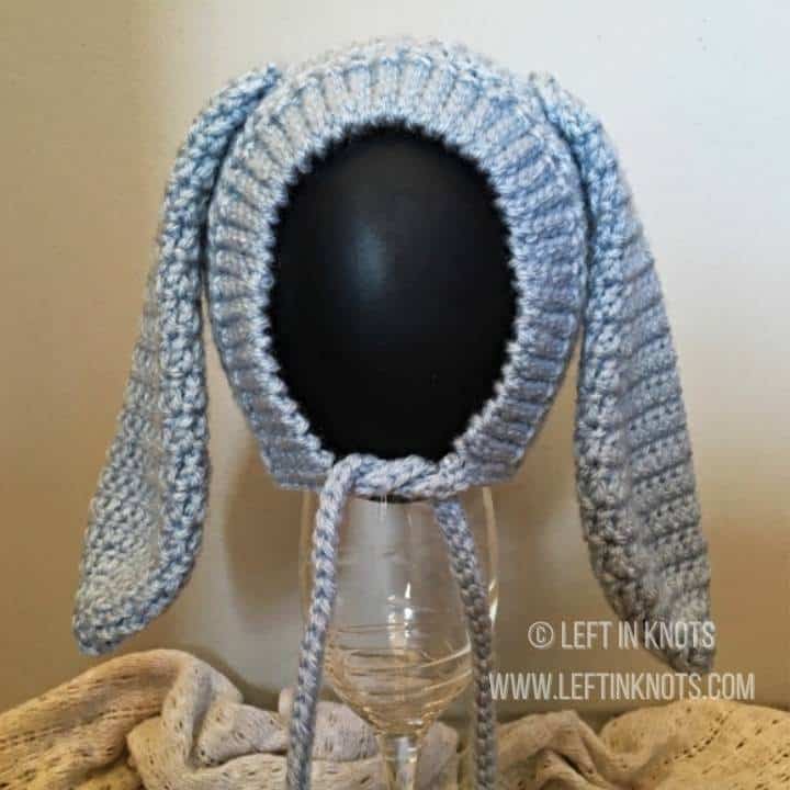 A blue crochet bunny bonnet with tie strings