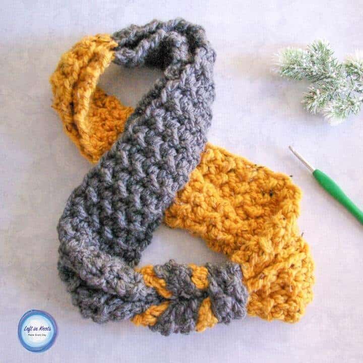 A yellow and gray knotted crochet infinity scarf