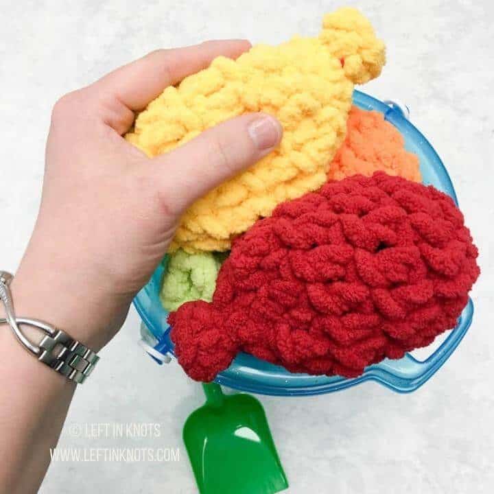 Colorful crochet reusable water balloons packaged for selling at craft fairs