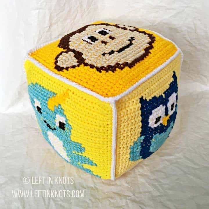 Yellow crochet block with animals on it