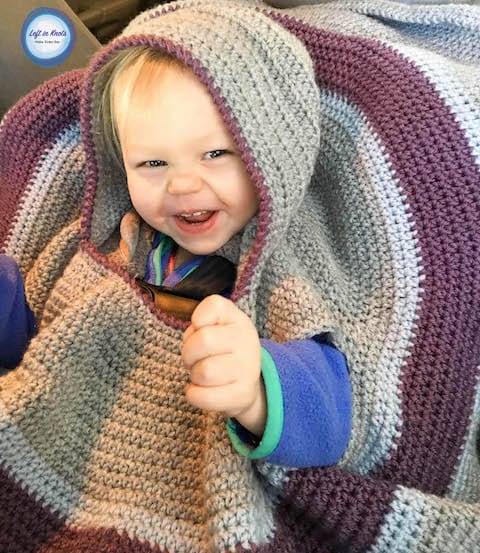 A hooded crochet car seat blanket for toddlers