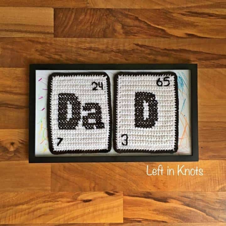 Crochet and cross stitched squares that spell Dad