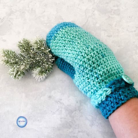 Turquoise crochet mittens with a braided cuff