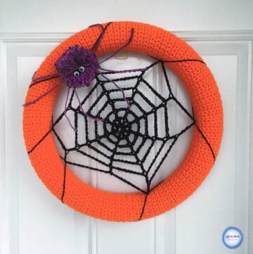 A crochet spider web wreath for Halloween