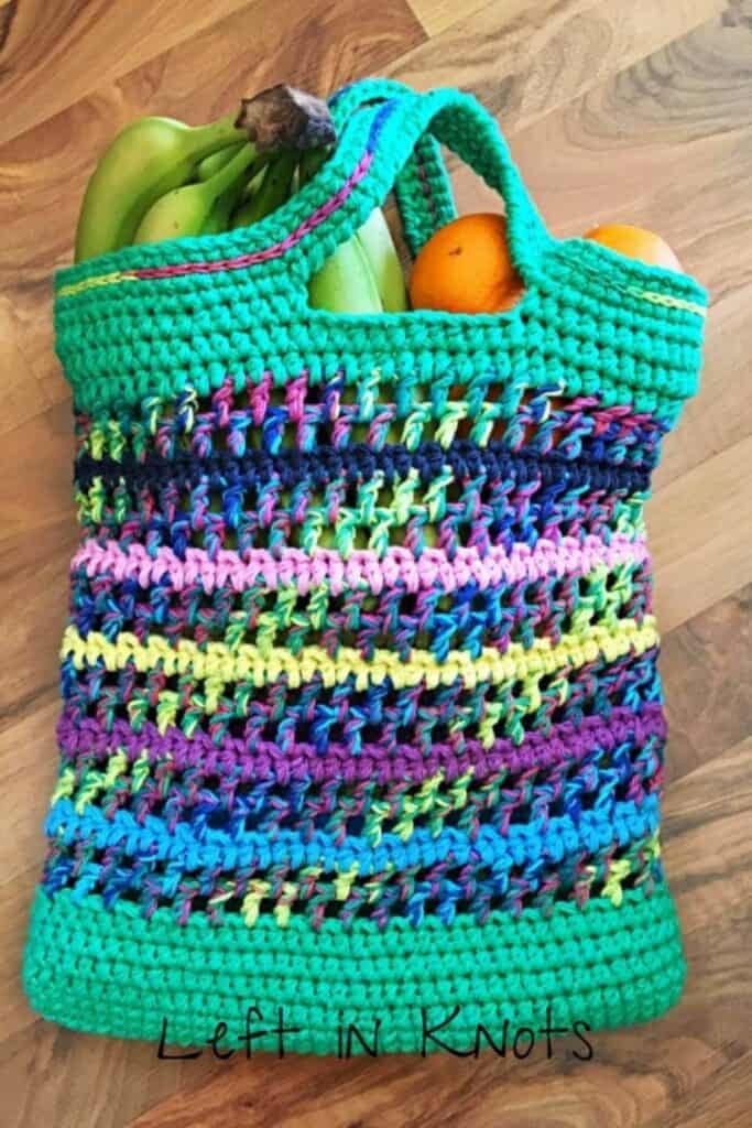 Colorful cotton crochet bag holding bananas and oranges