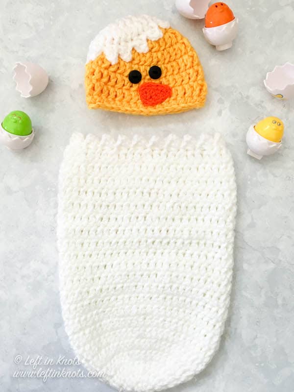 A crochet newborn baby chick cocoon and hat photo prop