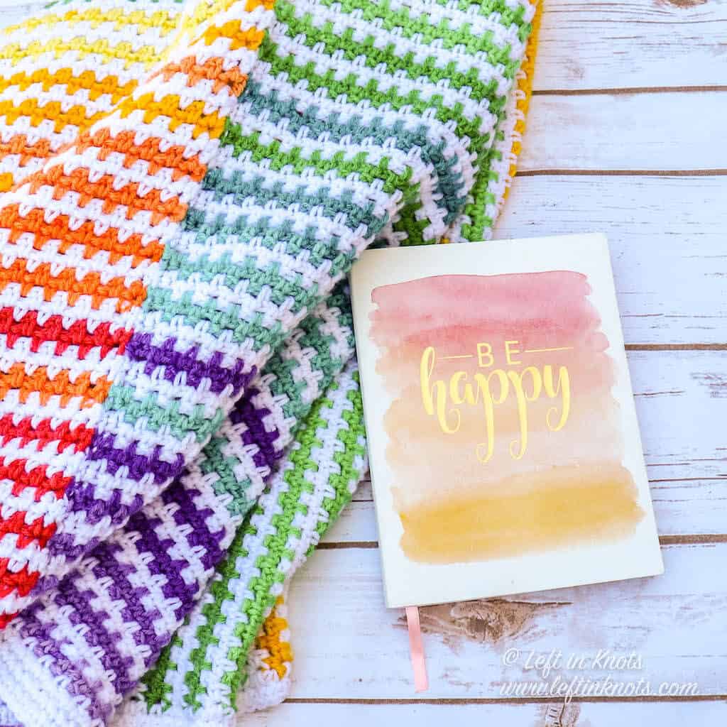 A rainbow striped crochet baby blanket