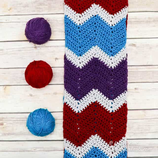 A crochet chevron scarf made in jewel tone yarn