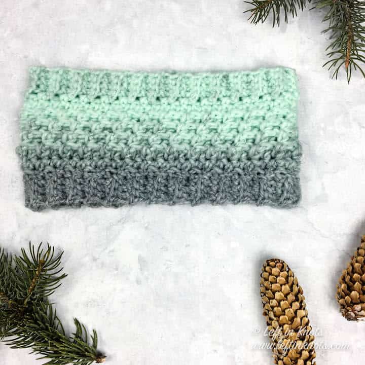 A mint and gray crochet ear warmer made with Lion Brand Scarfie