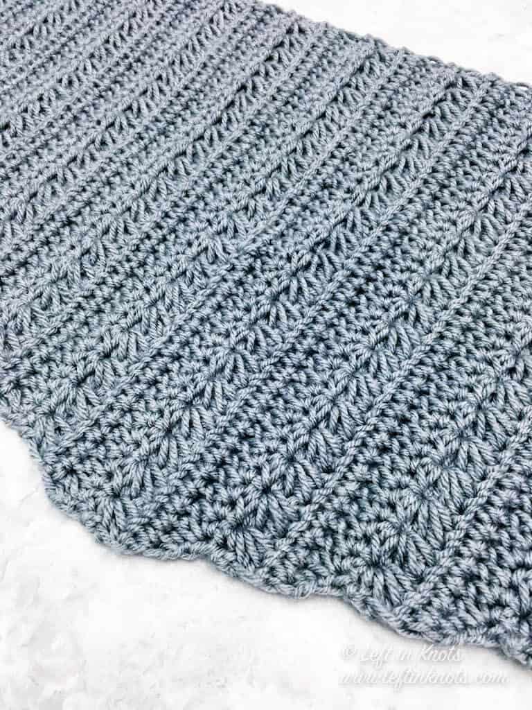 A modern crochet triangle scarf made with the star stitch