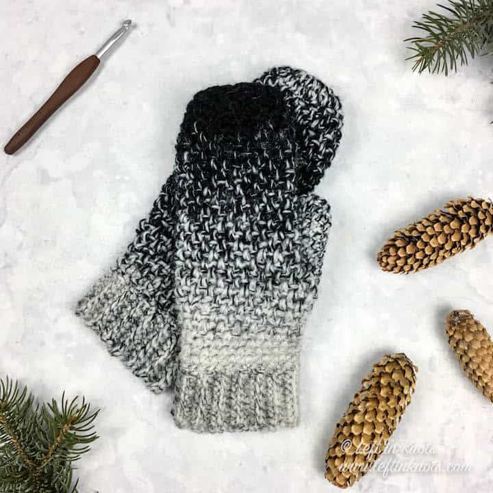 Black and white ombre crochet mittens made with the moss stitch