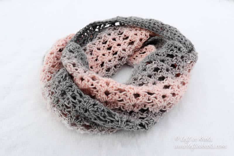 A pink and gray crochet cowl using the iris stitch
