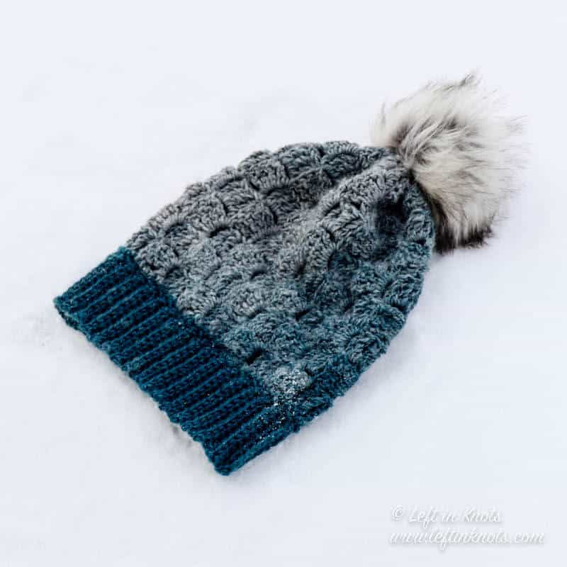 A blue and gray crochet beanie made with Lion Brand Scarfie yarn