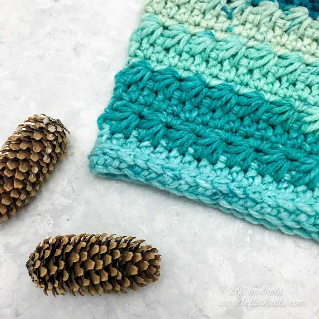 A turquoise crochet cowl made with the star stitch