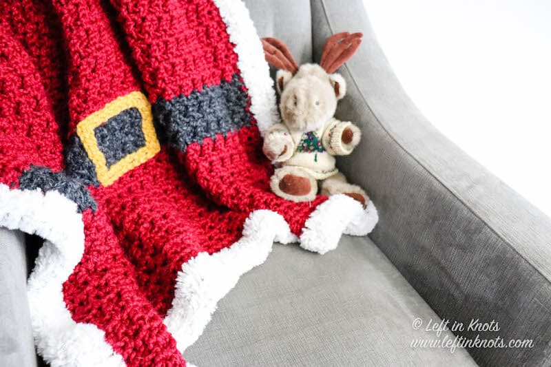 A red chunky Santa Christmas afghan with belt and fur border