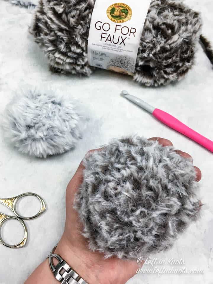 A crochet pom pom made with faux fur yarn
