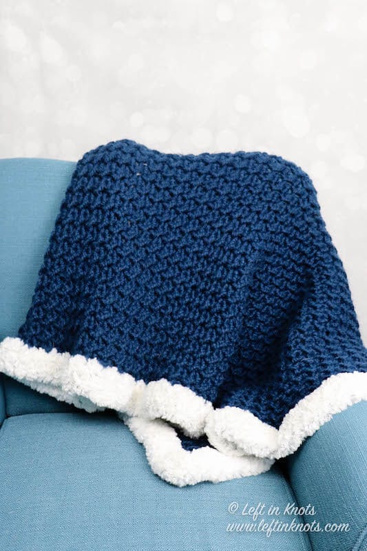 A chunky crochet throw blanket made with the crunch stitch