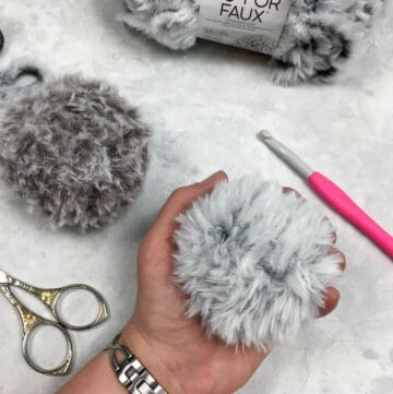 A crochet pom pom made with faux fur yarn