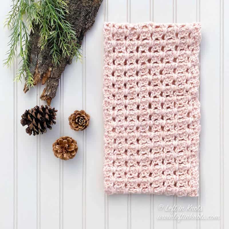 A blush crochet cowl made with chainette yarn