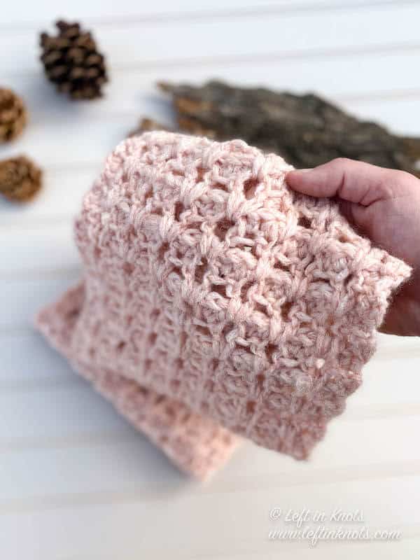 A blush crochet cowl made with chainette yarn