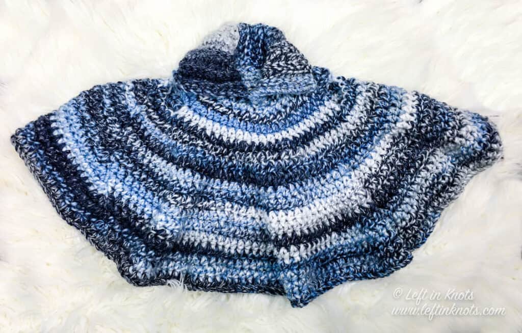 A crochet car seat poncho for toddlers made with chunky yarn