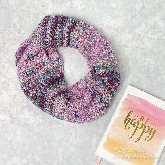 A crochet ombre infinity scarf made with hand dyed yarn and the moss stitch