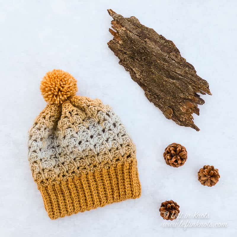 A gold and ice blue crochet beanie
