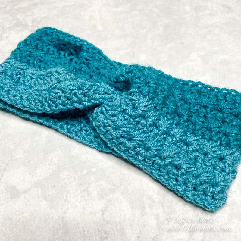 Turquoise crochet ear warmer made with the star stitch