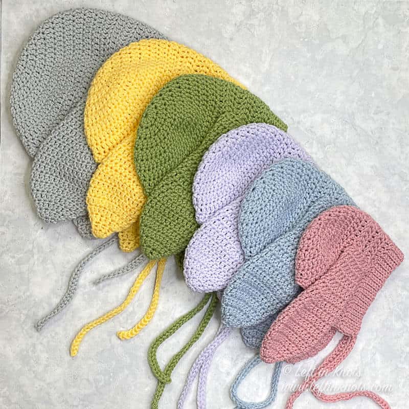 Crocheted bunny bonnets in a variety of pastel colors and sizes