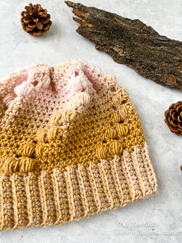 A gold and ice pink crocheted beanie
